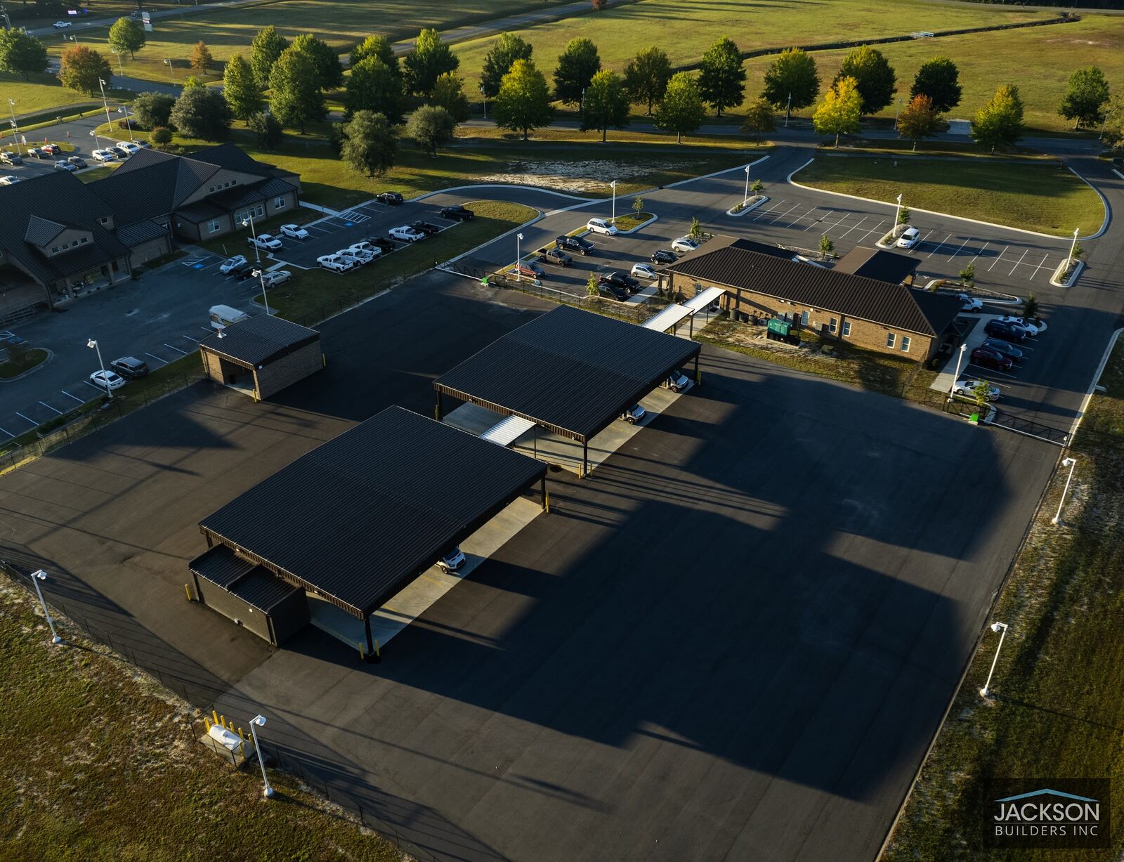 A drone view looking down on the campus's dark metal canopy roofs and fresh asphalt