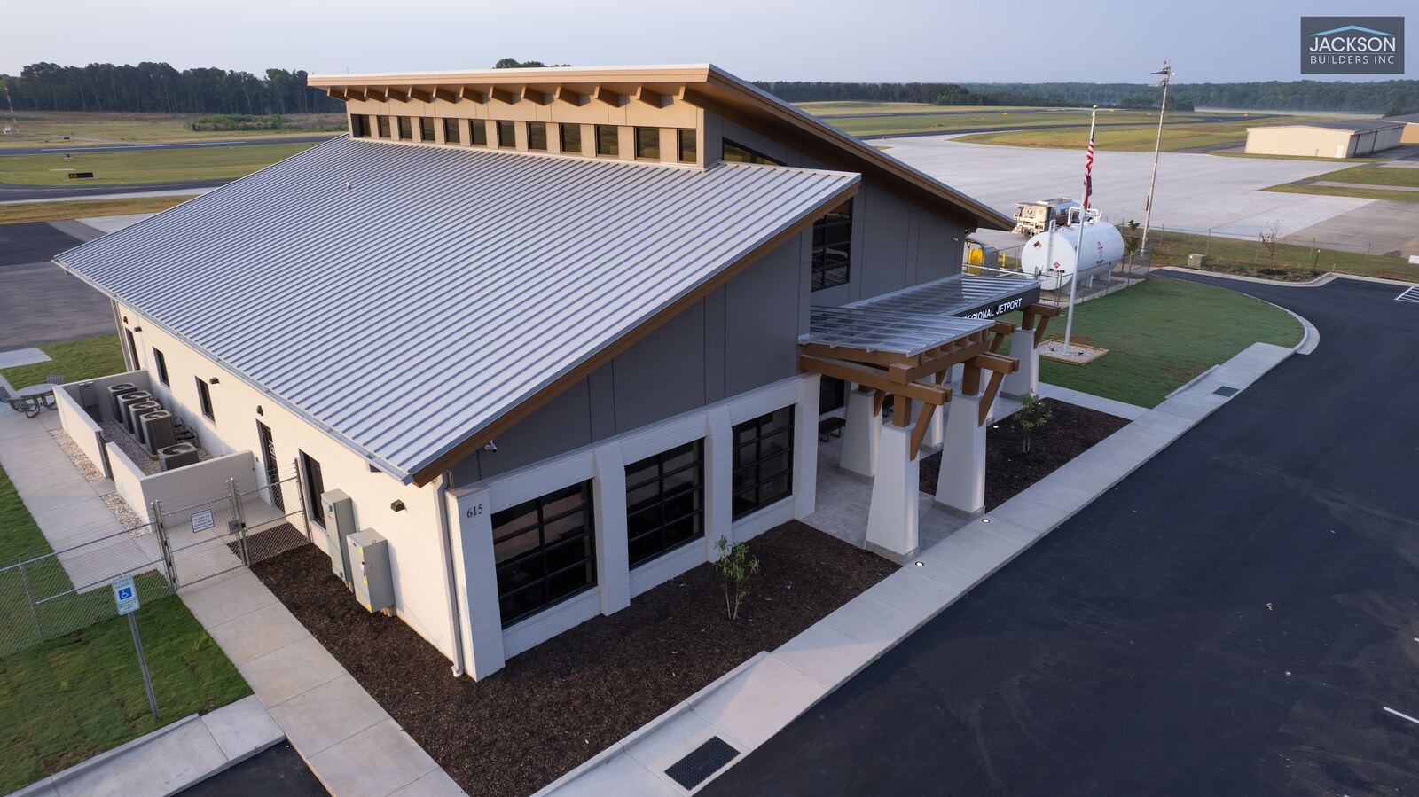 The terminal's sloped roofline and entrance from the edge of the parking lot